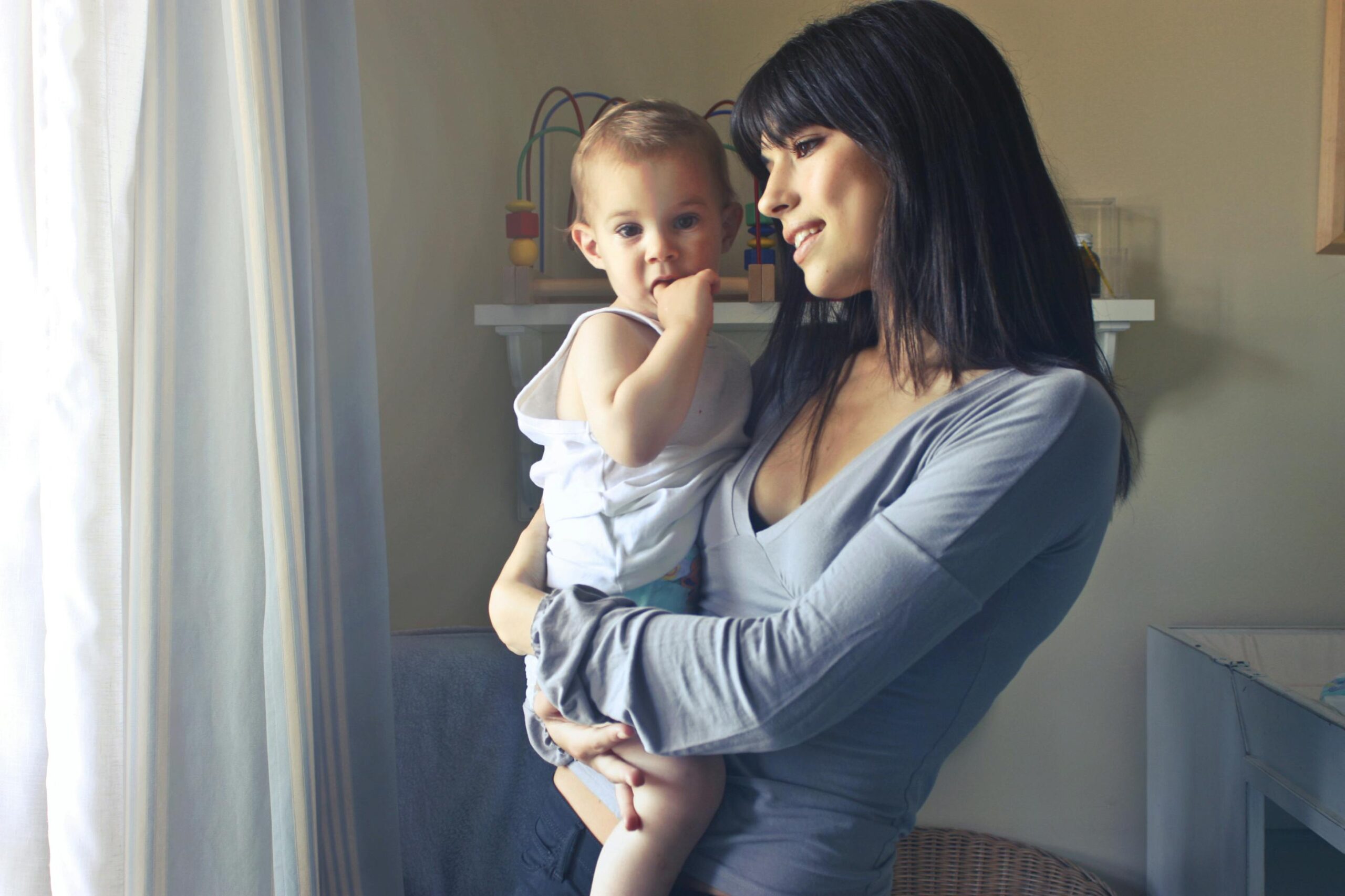 A loving moment between a mother and her child in an indoor setting, fostering connection and warmth.