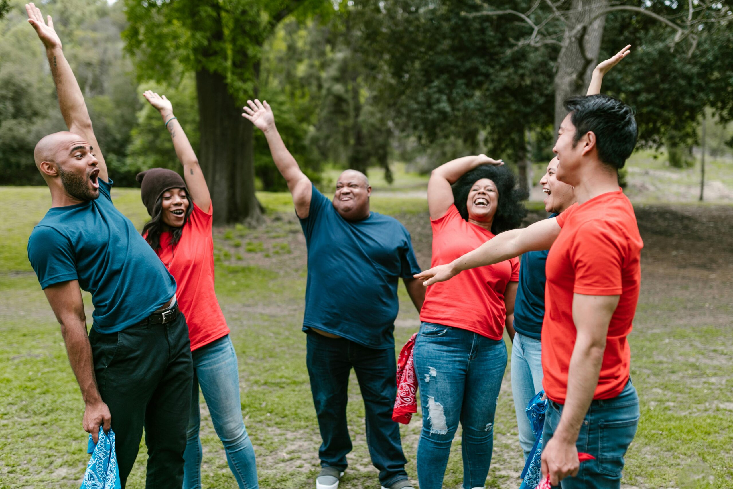 Group of diverse adults enjoying team bonding activities outdoors, radiating joy and togetherness.