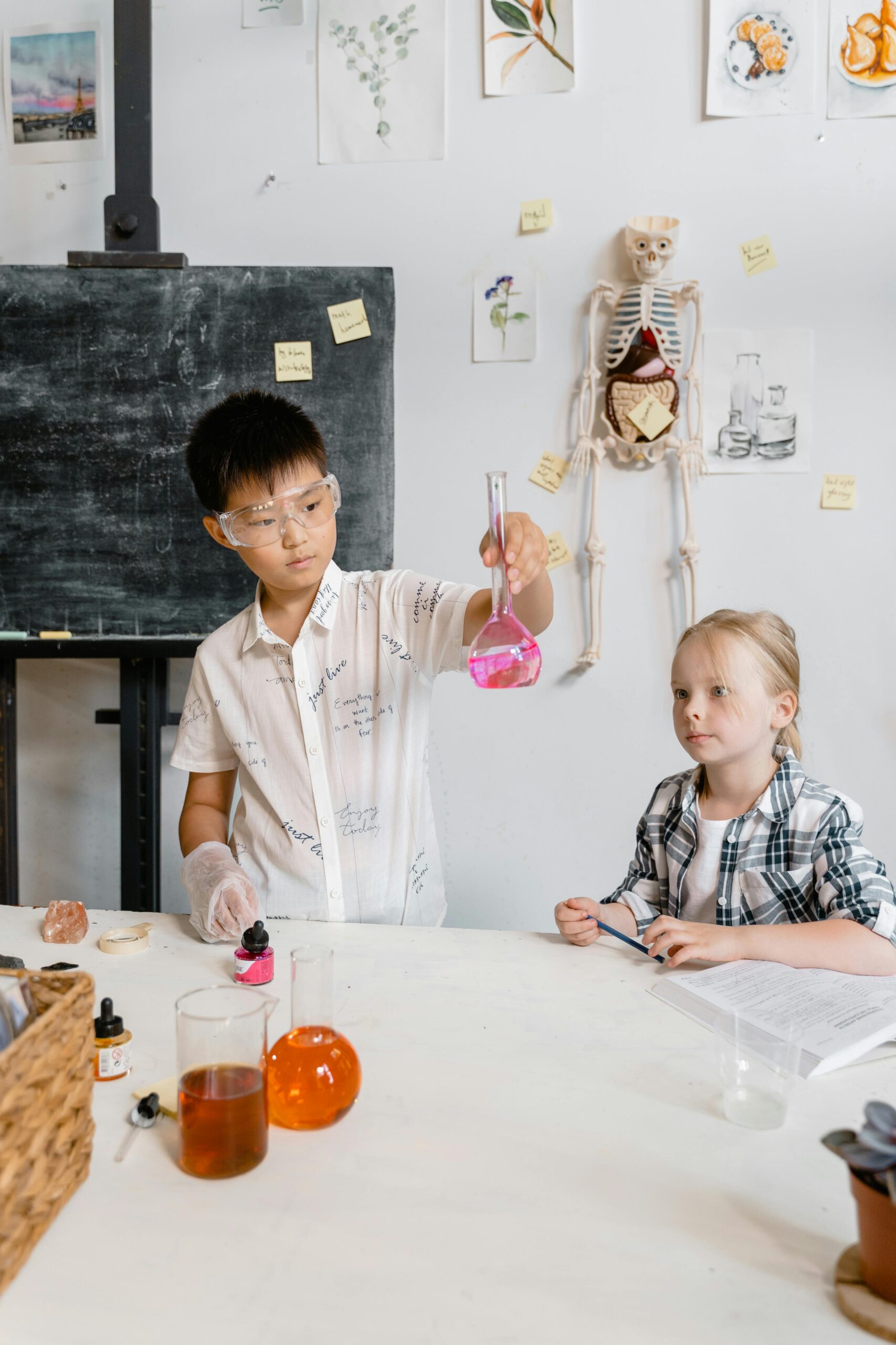 Children conducting a science experiment in a classroom setting with lab equipment.